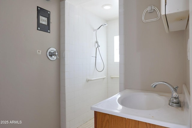 bathroom featuring vanity and a tile shower