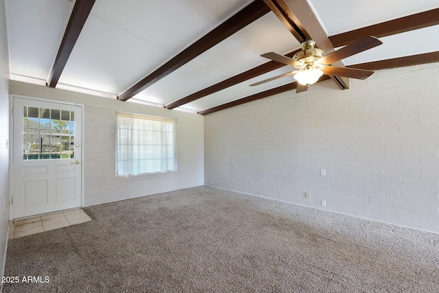 carpeted entrance foyer with ceiling fan, brick wall, and vaulted ceiling with beams