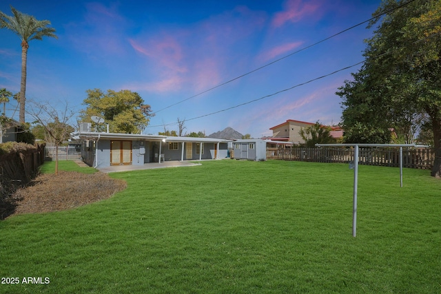 yard at dusk with a patio