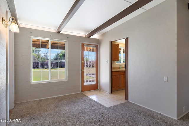 interior space with lofted ceiling with beams and light colored carpet