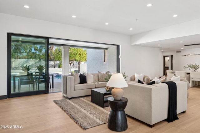 living area featuring recessed lighting and light wood-style flooring