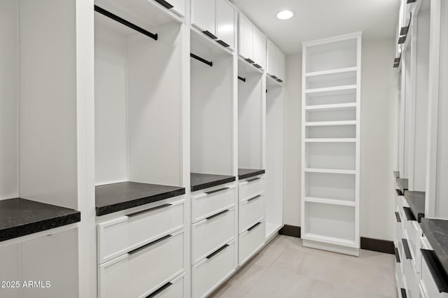 walk in closet with light tile patterned flooring