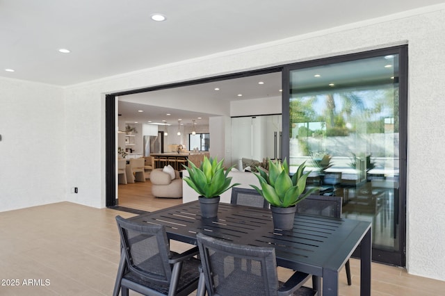 dining room featuring recessed lighting, light wood-type flooring, and ornamental molding