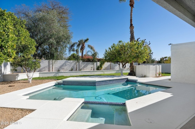 view of swimming pool with a fenced backyard and a pool with connected hot tub
