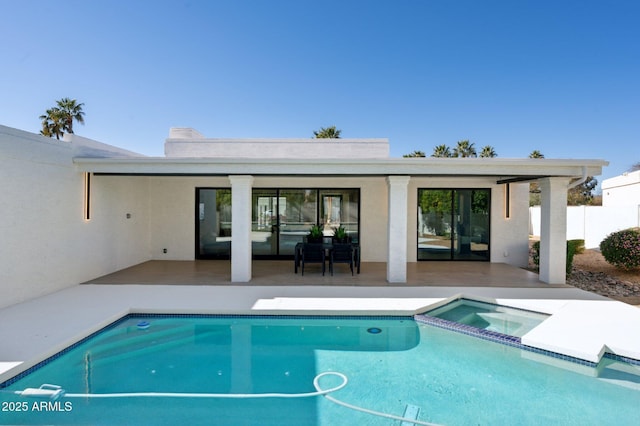 back of property with a patio, fence, a fenced in pool, an in ground hot tub, and stucco siding