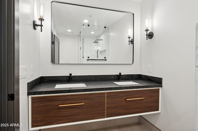 bathroom with a sink, recessed lighting, a stall shower, and double vanity