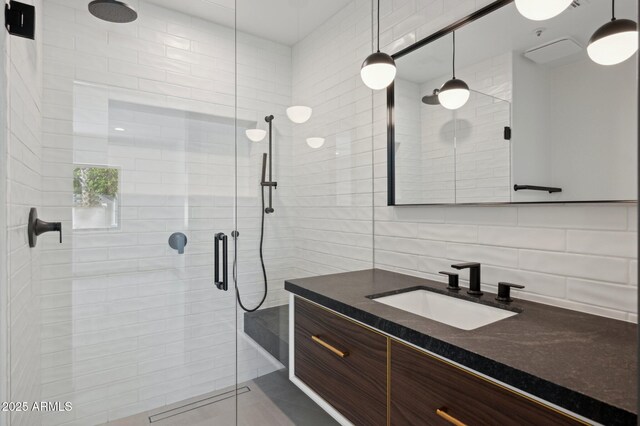 full bath with vanity, tile walls, backsplash, and a shower stall