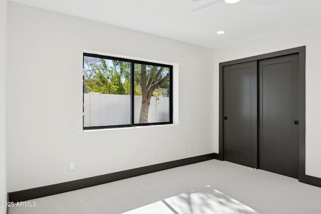 unfurnished bedroom featuring a ceiling fan, recessed lighting, a closet, carpet flooring, and baseboards