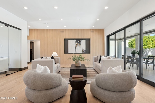 living area with recessed lighting and light wood-style flooring