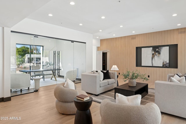 living area with recessed lighting and light wood-style flooring