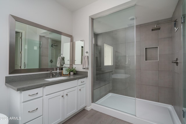 8513 N 172nd Ln, Waddell, AZ 85355 - bathroom with a shower stall, vanity, and wood finished floors