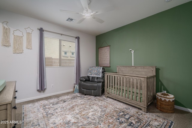 8513 N 172nd Ln, Waddell, AZ 85355 - carpeted bedroom featuring a nursery area, visible vents, baseboards, and ceiling fan