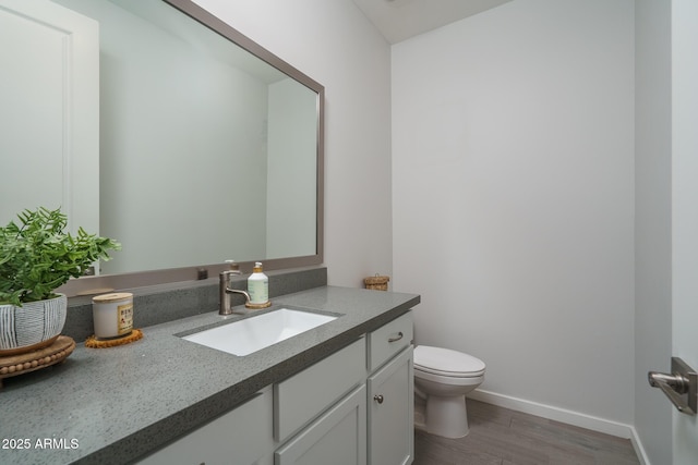 8513 N 172nd Ln, Waddell, AZ 85355 - bathroom featuring toilet, wood finished floors, vanity, and baseboards