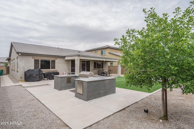 8513 N 172nd Ln, Waddell, AZ 85355 - view of patio / terrace featuring area for grilling, fence, and exterior kitchen