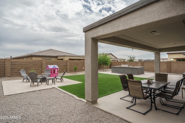 8513 N 172nd Ln, Waddell, AZ 85355 - view of patio / terrace featuring outdoor dining space, a fenced backyard, and an outdoor fire pit