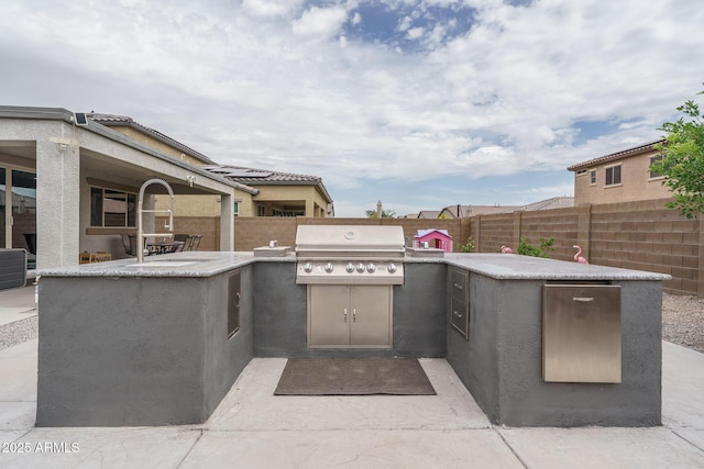 8513 N 172nd Ln, Waddell, AZ 85355 - view of patio featuring a fenced backyard, exterior kitchen, and area for grilling