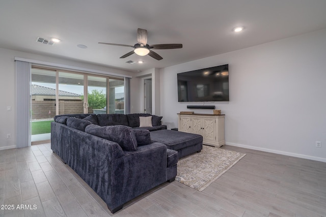 8513 N 172nd Ln, Waddell, AZ 85355 - living room featuring visible vents, ceiling fan, light wood-style floors, and baseboards