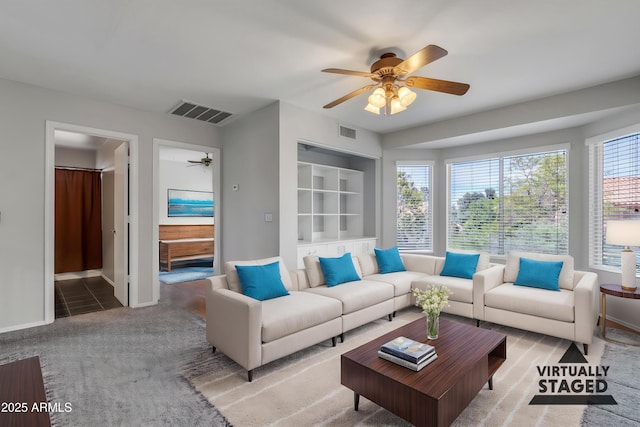 2340 W Myrtle Dr, Chandler, AZ 85248 - living room featuring visible vents, baseboards, ceiling fan, and light carpet