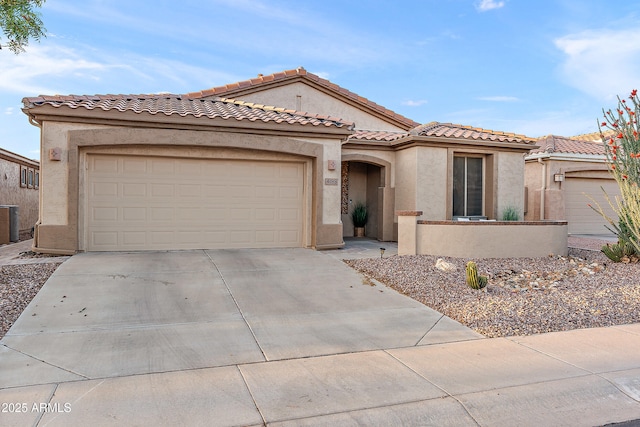 4088 E Jude Ln, Gilbert, AZ 85298 - mediterranean / spanish-style house featuring concrete driveway, stucco siding, a tiled roof, and an attached garage