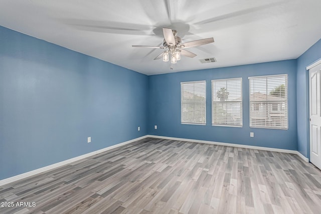 10440 E Osage Ave, Mesa, AZ 85212 - unfurnished room with wood finished floors, ceiling fan, and baseboards