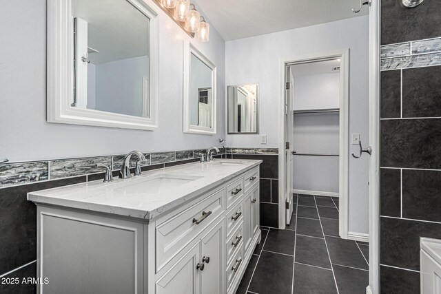 10440 E Osage Ave, Mesa, AZ 85212 - bathroom with tile walls, double vanity, tile patterned floors, and a wainscoted wall