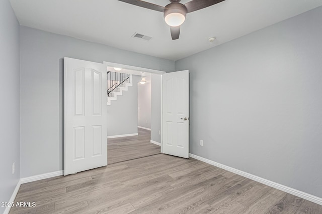 10440 E Osage Ave, Mesa, AZ 85212 - unfurnished bedroom with light wood-type flooring, baseboards, and a ceiling fan