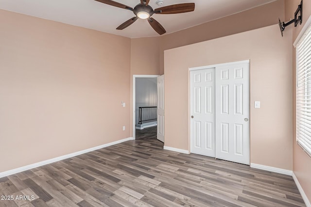 10440 E Osage Ave, Mesa, AZ 85212 - unfurnished bedroom featuring wood finished floors, baseboards, a closet, and a ceiling fan