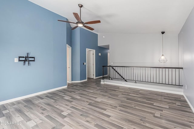 10440 E Osage Ave, Mesa, AZ 85212 - unfurnished room with ceiling fan, wood finished floors, baseboards, and high vaulted ceiling