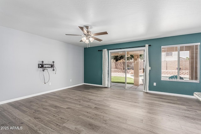 10440 E Osage Ave, Mesa, AZ 85212 - unfurnished room with wood finished floors, ceiling fan, and baseboards