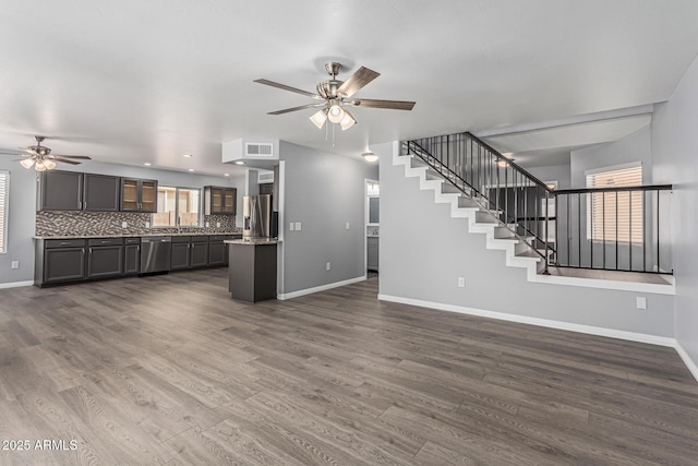 10440 E Osage Ave, Mesa, AZ 85212 - unfurnished living room featuring ceiling fan, baseboards, stairs, and dark wood-style floors