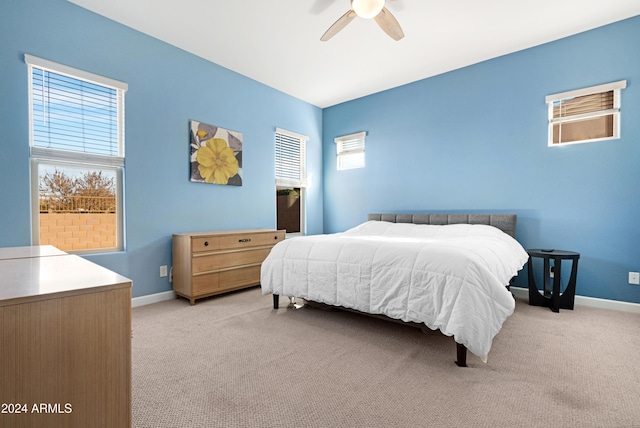 bedroom featuring light colored carpet and ceiling fan