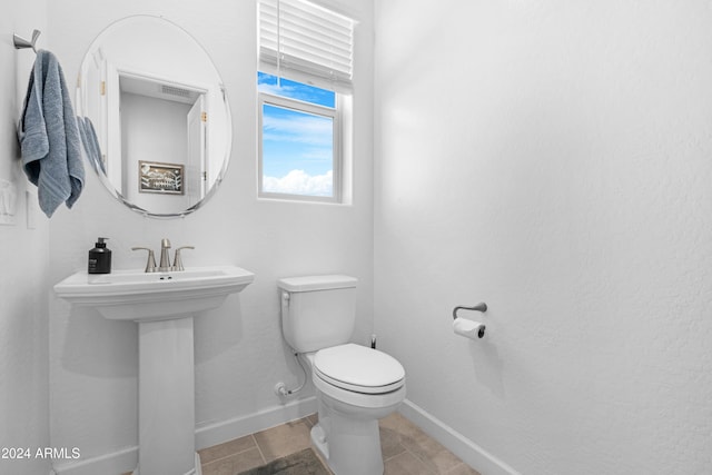 bathroom with toilet and tile patterned flooring