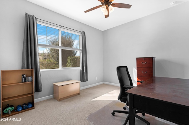 carpeted office featuring ceiling fan