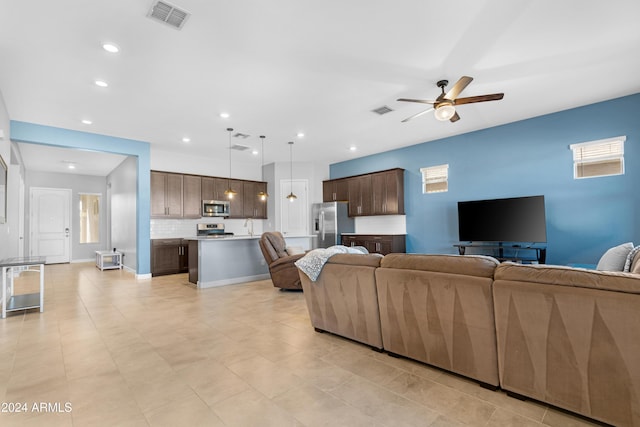 living room with sink and ceiling fan