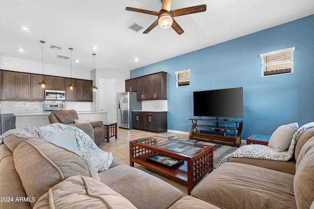 tiled living room featuring ceiling fan