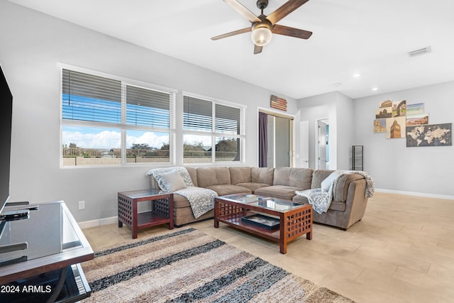 living room with light tile patterned flooring and ceiling fan