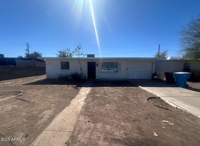 ranch-style home with concrete driveway and an attached garage