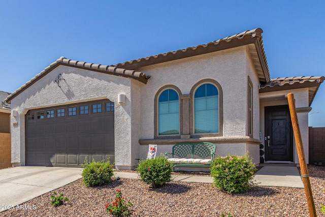 16750 W Evergreen Rd, Waddell, AZ 85355 - mediterranean / spanish house with a garage, stucco siding, driveway, and a tiled roof