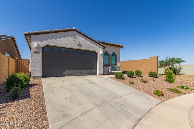 16750 W Evergreen Rd, Waddell, AZ 85355 - mediterranean / spanish-style house featuring an attached garage, concrete driveway, stucco siding, and a tiled roof