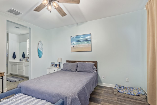 16750 W Evergreen Rd, Waddell, AZ 85355 - bedroom featuring wood finished floors, baseboards, ensuite bath, and a ceiling fan