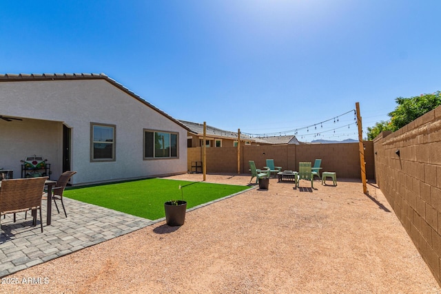 16750 W Evergreen Rd, Waddell, AZ 85355 - fenced backyard with a fire pit and a patio