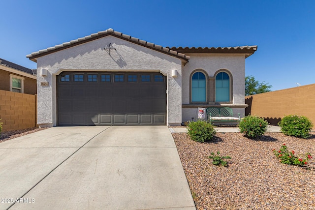 16750 W Evergreen Rd, Waddell, AZ 85355 - mediterranean / spanish house with driveway, a garage, stucco siding, and a tile roof