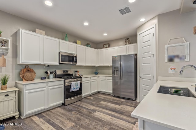 16750 W Evergreen Rd, Waddell, AZ 85355 - kitchen with stainless steel appliances, dark wood-type flooring, recessed lighting, light countertops, and a sink