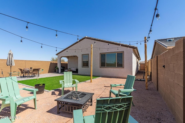 16750 W Evergreen Rd, Waddell, AZ 85355 - back of house featuring a fire pit, a fenced backyard, a patio area, and stucco siding