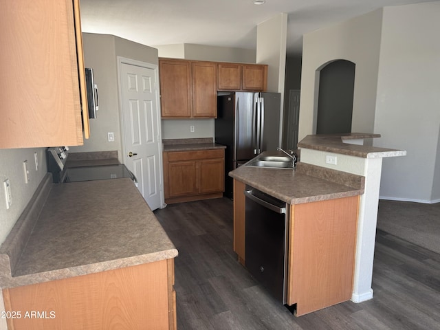 kitchen featuring dark hardwood / wood-style flooring, stainless steel appliances, a kitchen island, and sink