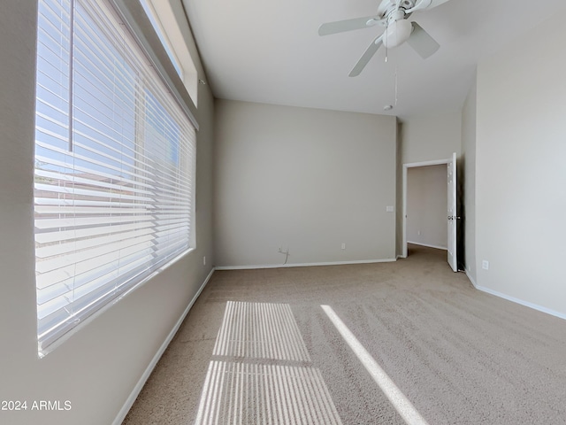 spare room featuring ceiling fan and light colored carpet