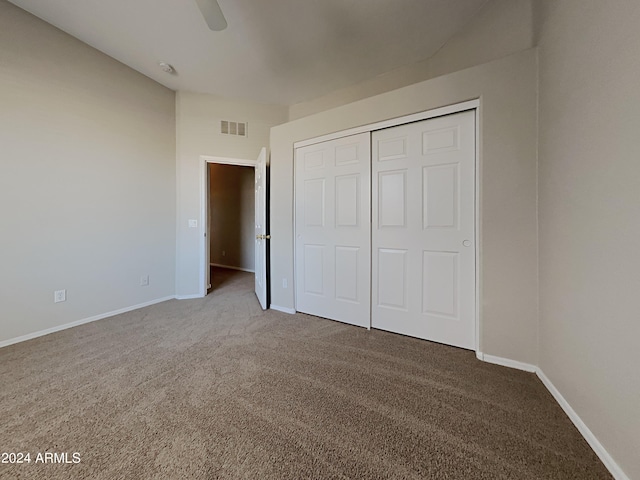 unfurnished bedroom with carpet flooring, a closet, and ceiling fan