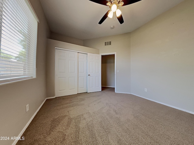 unfurnished bedroom featuring carpet flooring, a closet, and ceiling fan