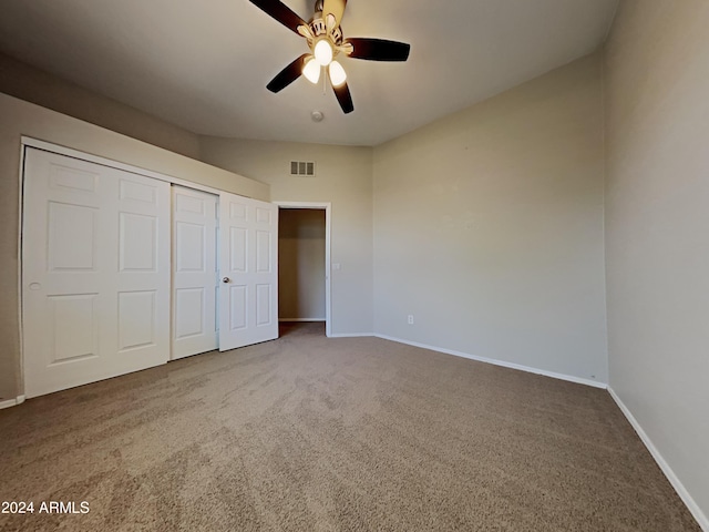 unfurnished bedroom featuring carpet floors, a closet, and ceiling fan