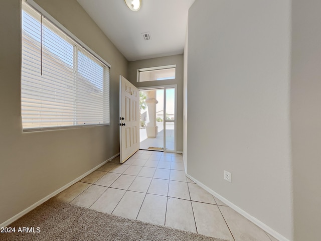 doorway to outside featuring light tile patterned flooring